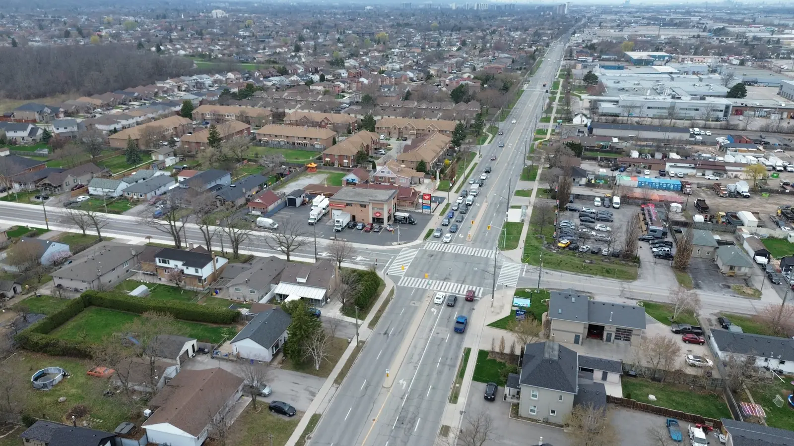 High aerial looking along Barton Street East showing the corridor, the intersection, and the surrounding neighbourhoods