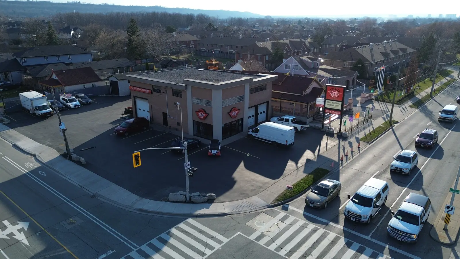 Aerial view of the rear of the corner lot showing the service building, rear yard, and surrounding streets