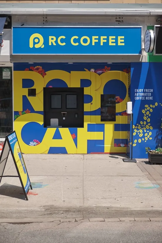 RC Coffee Robo Cafe storefront in blue and yellow with a pickup hatch