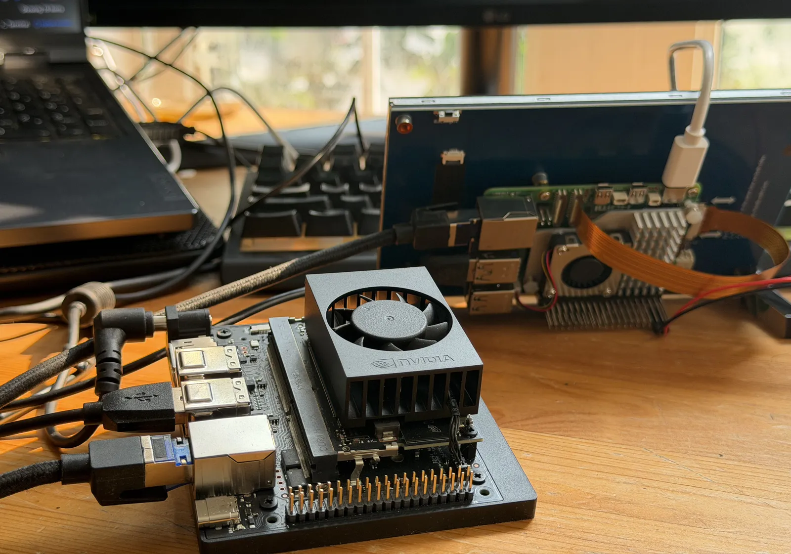 Port-side detail of the edge computer: fan shroud, module, carrier board, and header pins