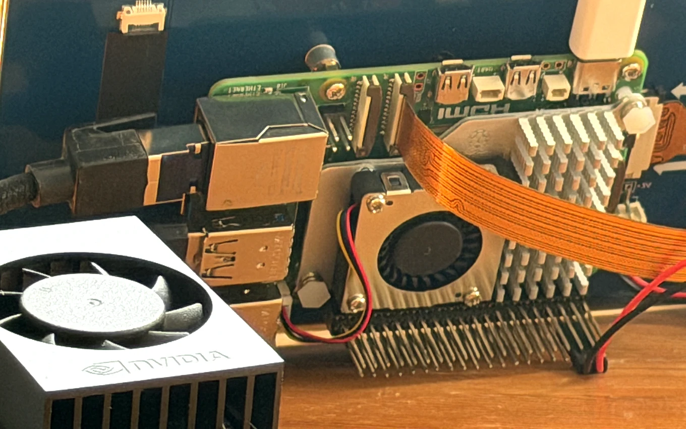 An NVIDIA-branded heatsink and fan on a Jetson-class edge computer, the NVIDIA wordmark legible, wired up on a workbench beside the board.