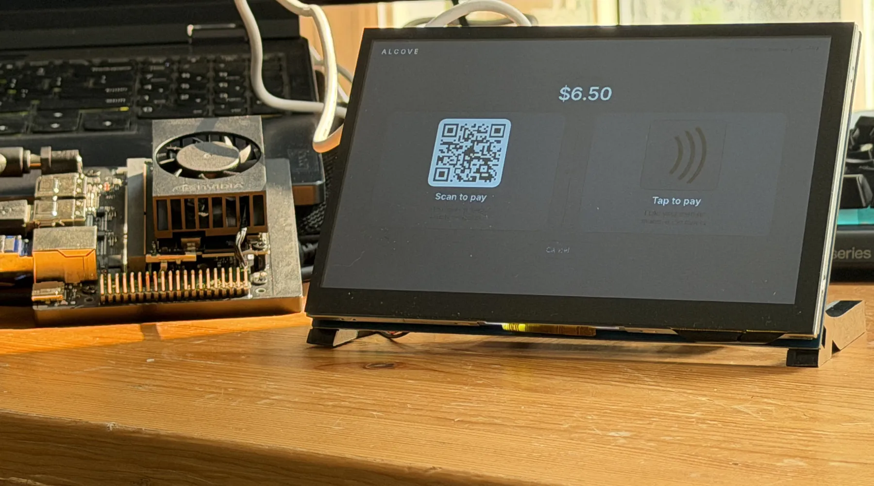 The edge computer and the checkout unit side by side on the bench, the unit showing a $6.50 scan-to-pay and tap-to-pay screen